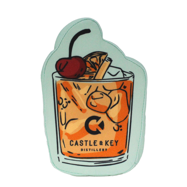 A plush dog toy designed to look like a cocktail glass with a cherry on top.