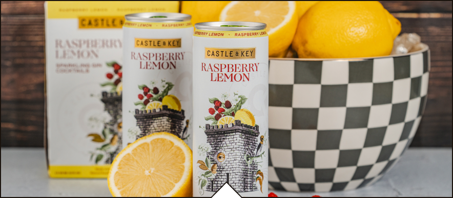 Raspberry Lemon Sparkling Gin Cocktail cans with lemons